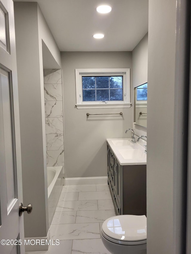 bathroom featuring toilet, recessed lighting, vanity, baseboards, and marble finish floor