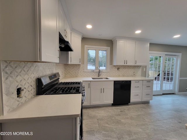 kitchen with under cabinet range hood, a sink, light countertops, stainless steel range with gas cooktop, and dishwasher