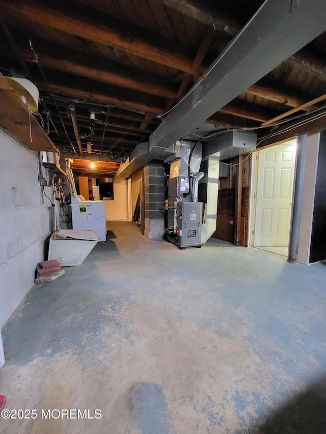 unfinished basement featuring heating unit