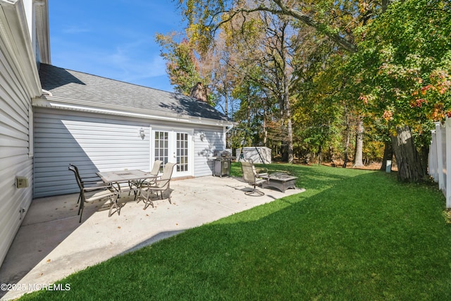 view of yard featuring a patio area, fence, and french doors