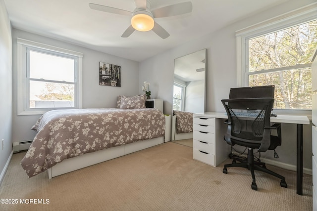 bedroom with carpet, a baseboard heating unit, and a ceiling fan