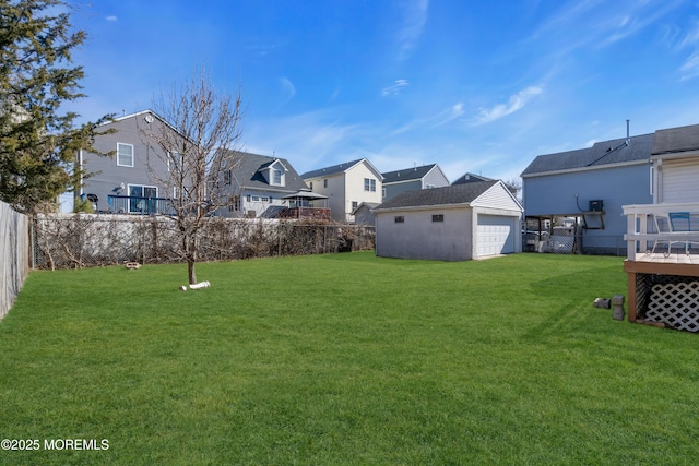 view of yard featuring a residential view, a fenced backyard, and an outdoor structure