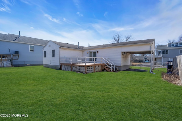 back of property with a yard, a carport, fence, and a wooden deck