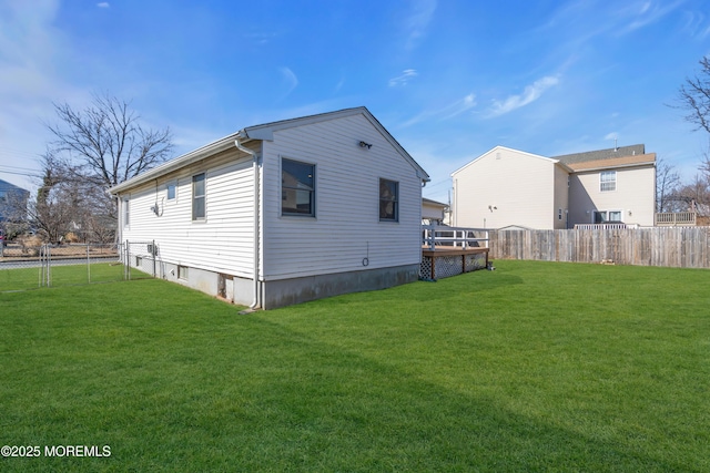 view of side of property featuring fence private yard and a lawn