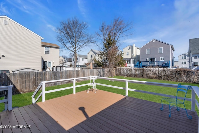 deck with a residential view, fence, and a lawn