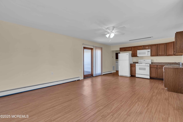 kitchen with white appliances, ceiling fan, a baseboard heating unit, and wood finished floors