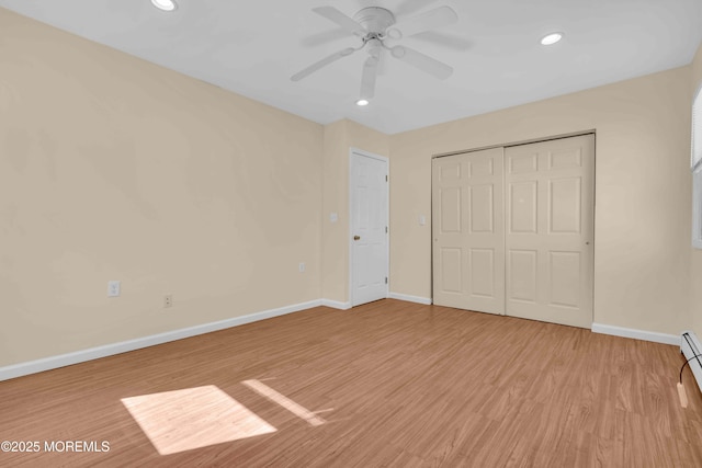 unfurnished bedroom featuring light wood-style floors, baseboards, a closet, and recessed lighting