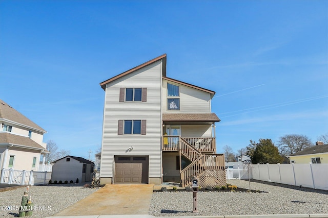 view of front of home featuring driveway, stairs, a garage, and fence