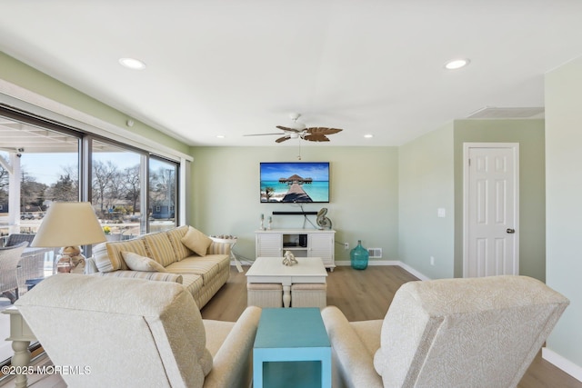 living area featuring wood finished floors, recessed lighting, baseboards, and visible vents