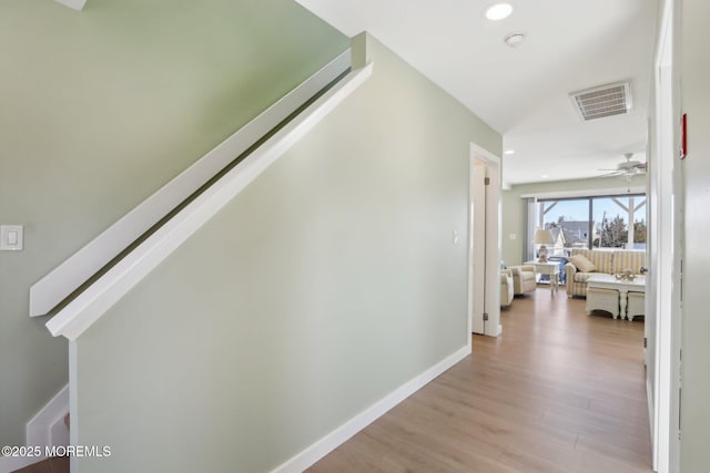 corridor with visible vents, recessed lighting, baseboards, and light wood-style floors