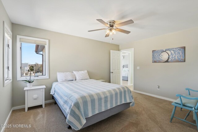 carpeted bedroom with baseboards and a ceiling fan