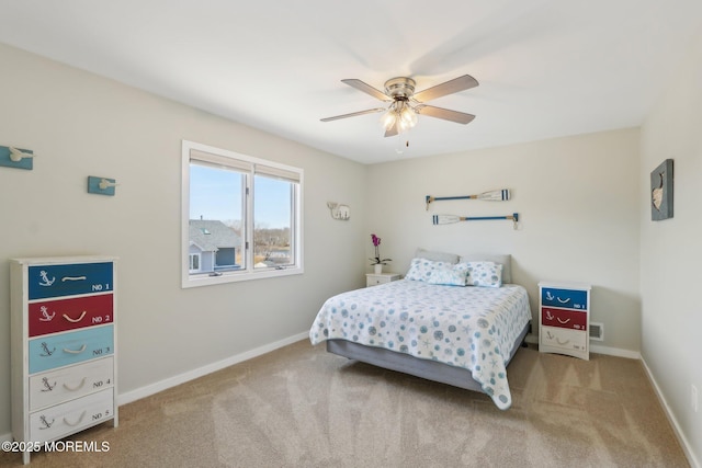 carpeted bedroom with baseboards and ceiling fan