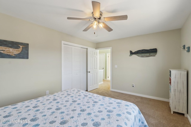 bedroom featuring a closet, baseboards, ceiling fan, and carpet flooring