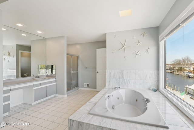 bathroom with tile patterned flooring, a shower stall, a jetted tub, a water view, and vanity