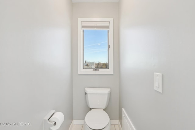 bathroom featuring tile patterned flooring, toilet, visible vents, and baseboards