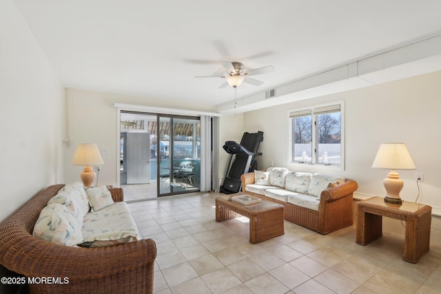 living room featuring light tile patterned floors, a ceiling fan, and visible vents