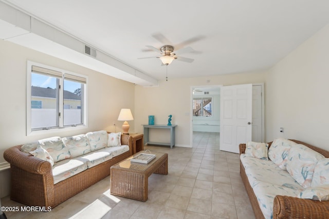 living area with visible vents, ceiling fan, and light tile patterned flooring