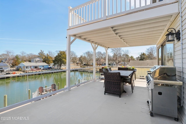 view of patio / terrace with outdoor dining space and a water view