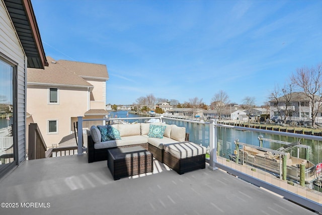 exterior space with an outdoor hangout area, a balcony, and a water view