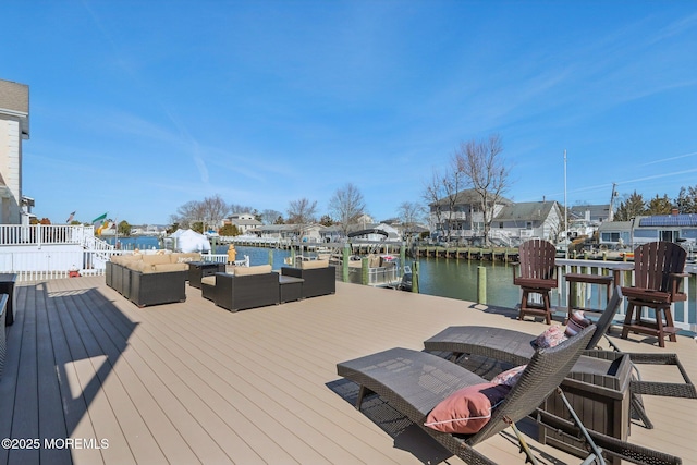 dock area with an outdoor living space and a water view