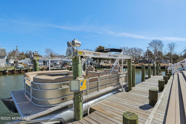 dock area with a water view and boat lift