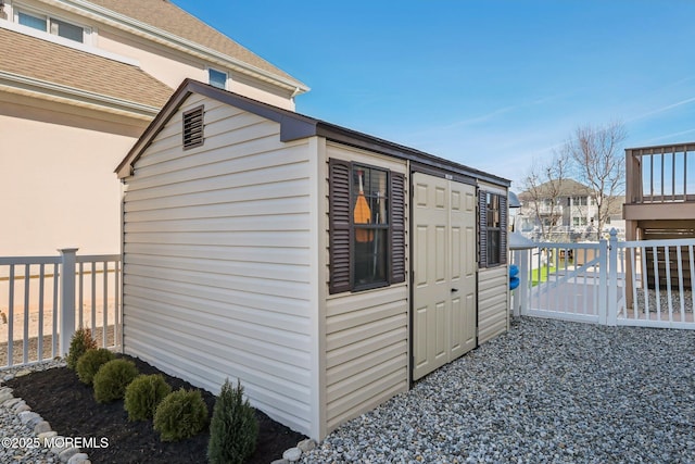 view of outbuilding with an outbuilding, a residential view, and fence