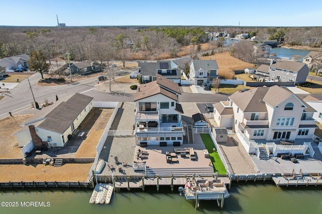 birds eye view of property with a water view and a residential view