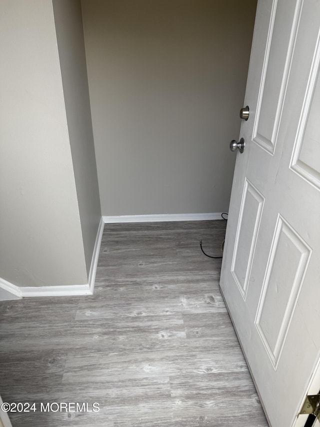 empty room featuring baseboards and wood finished floors