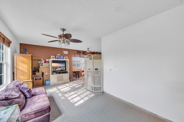 living room featuring a healthy amount of sunlight, light carpet, and a textured ceiling