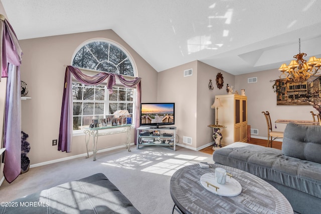 carpeted living room featuring an inviting chandelier, visible vents, and vaulted ceiling