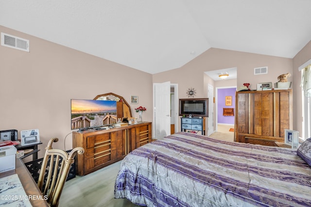 bedroom with lofted ceiling, carpet floors, and visible vents