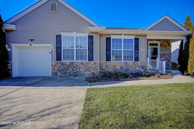 ranch-style house featuring a garage, a front yard, stone siding, and driveway