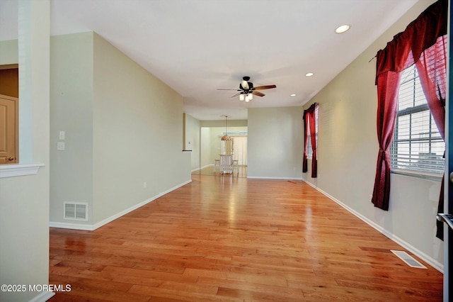 interior space with a ceiling fan, recessed lighting, visible vents, and light wood finished floors