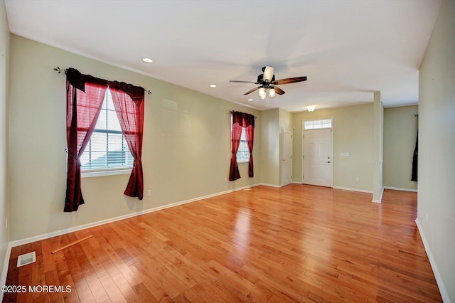 empty room featuring ceiling fan, recessed lighting, visible vents, baseboards, and light wood finished floors