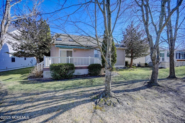 view of front of home featuring a wooden deck and a front lawn