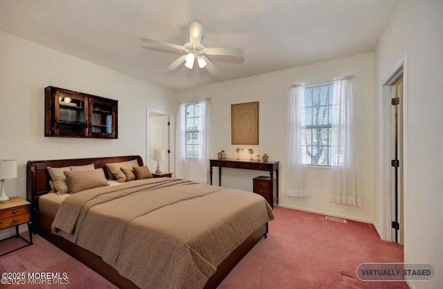 carpeted bedroom featuring baseboards and a ceiling fan