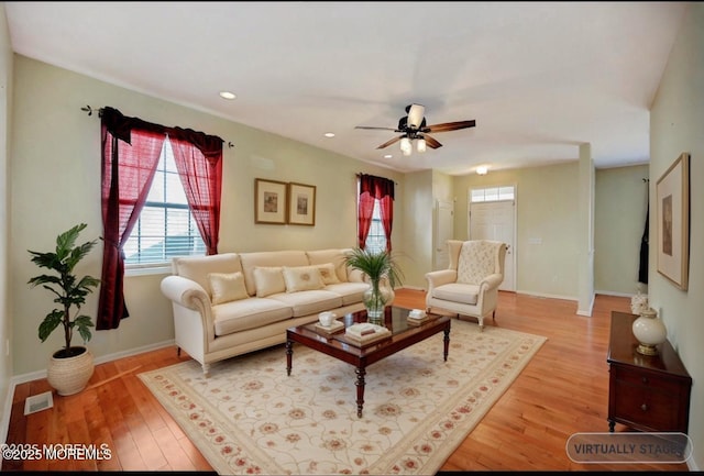 living area featuring recessed lighting, visible vents, a ceiling fan, wood finished floors, and baseboards