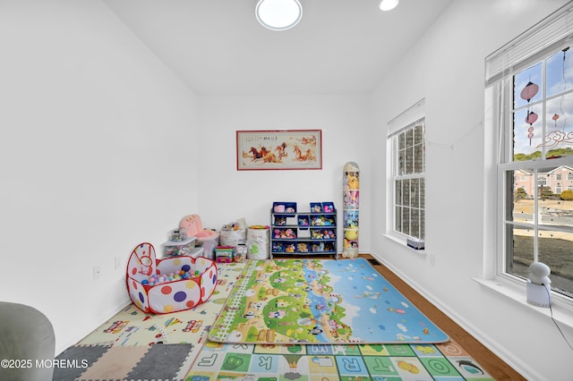 game room featuring baseboards and wood finished floors