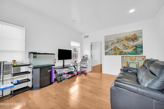 living area featuring visible vents, wood finished floors, and recessed lighting