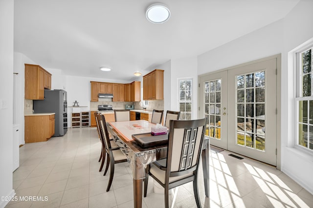 dining space featuring a wealth of natural light, french doors, and visible vents