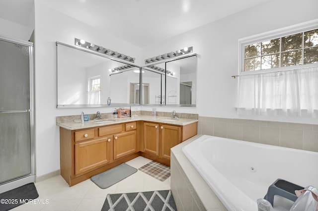 bathroom featuring a jetted tub, a stall shower, and a sink