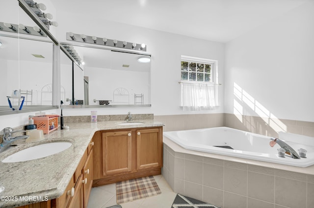 full bathroom with a jetted tub, double vanity, a sink, and tile patterned floors