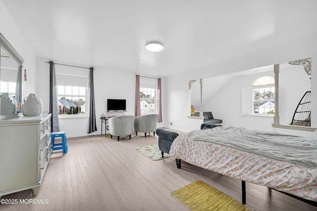 bedroom with light wood-style floors and baseboards