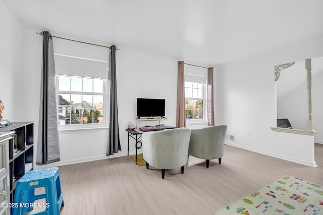 interior space with wood finished floors, visible vents, and baseboards