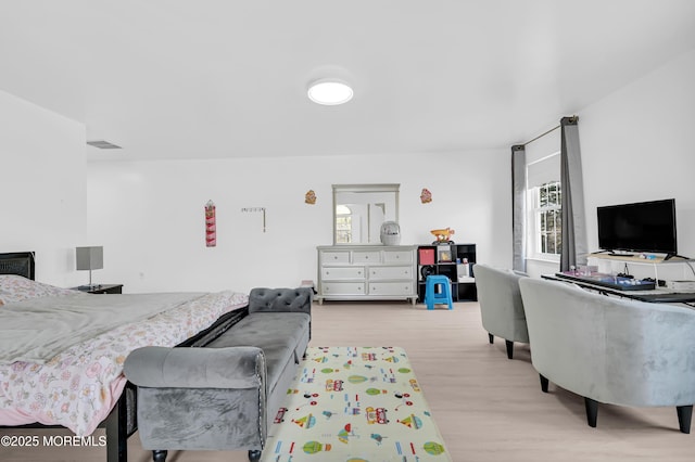 bedroom featuring visible vents and wood finished floors