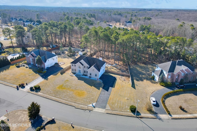 birds eye view of property featuring a wooded view