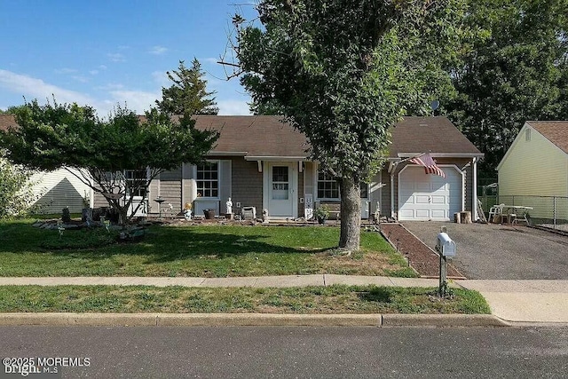 view of front of property with a garage, driveway, and a front lawn