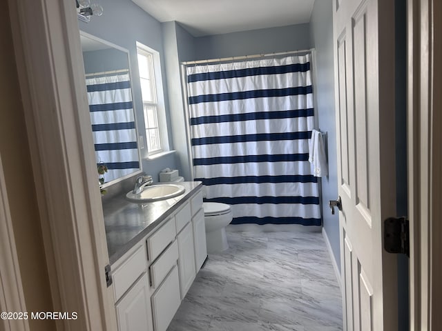 bathroom featuring toilet, marble finish floor, curtained shower, and vanity