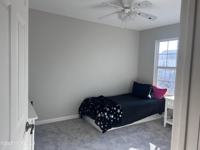 carpeted bedroom featuring a ceiling fan and baseboards