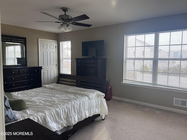 bedroom featuring a ceiling fan, carpet, visible vents, and baseboards